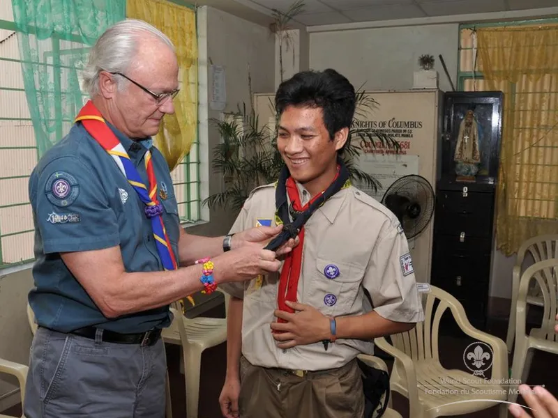 Jerwin receiving His Majesty's scarf