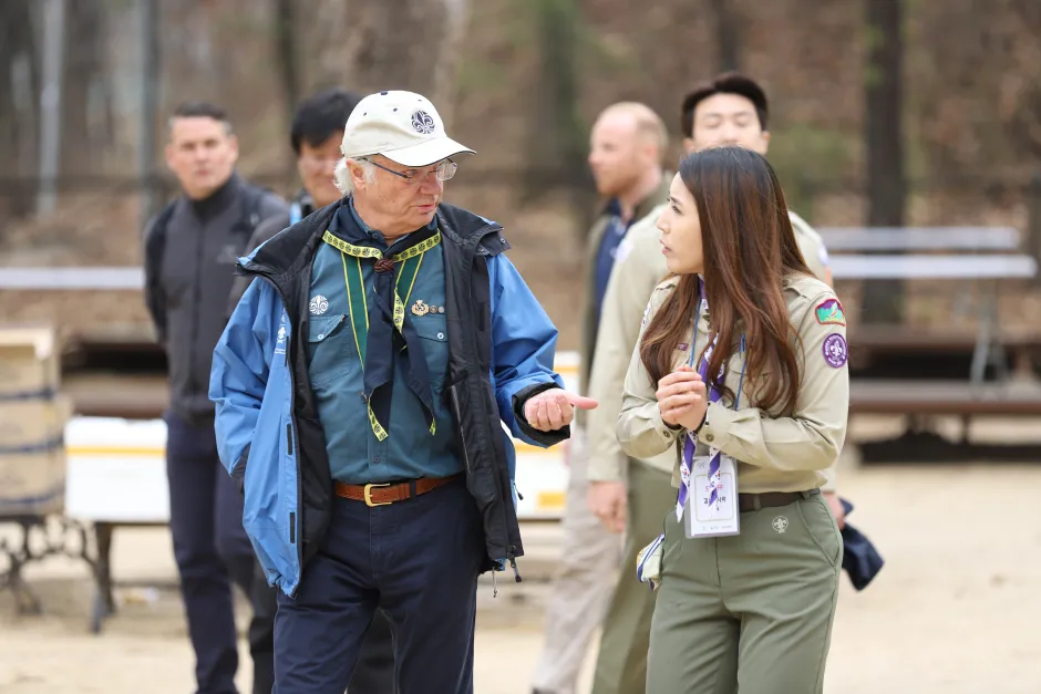 HM The King of Sweden being guided around the Korea Scout Environmnent Activity by Ms Yubinnara (Lisa) Kim
