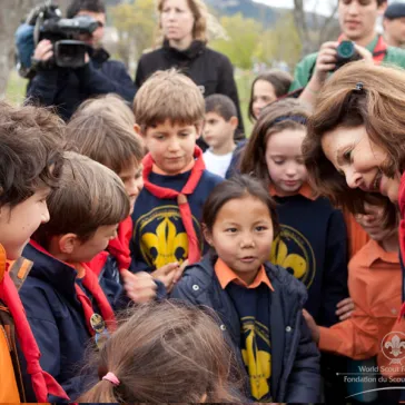 Her Majesty talking and assisting the jongest members.